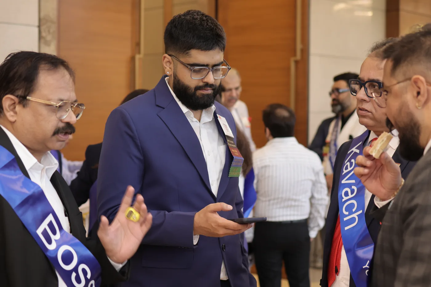 Chirant working from his phone at a professional gathering